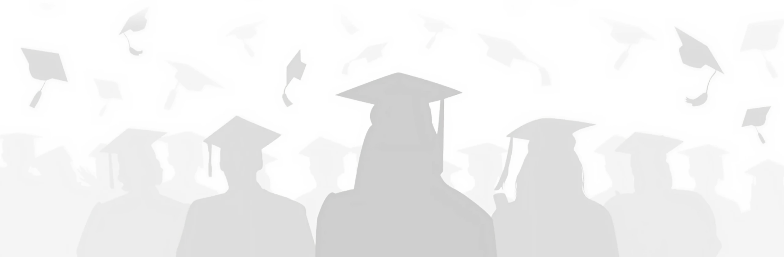 Graduates with caps in the air.